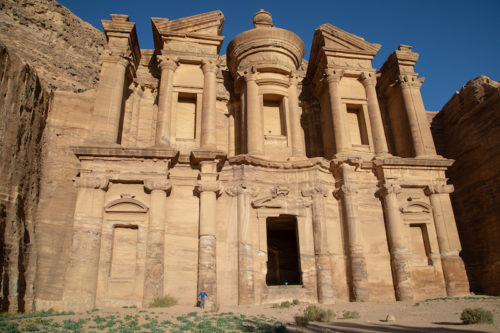 a photo of erik standing at base of entrance to petra