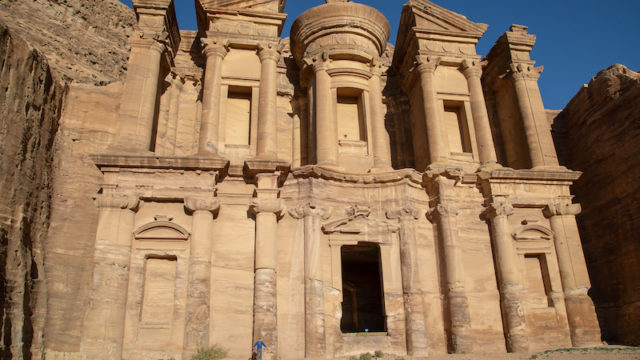 a photo of erik standing at base of entrance to petra