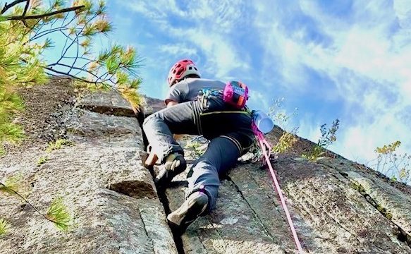 Erik navigating a crack with sunny skies above.