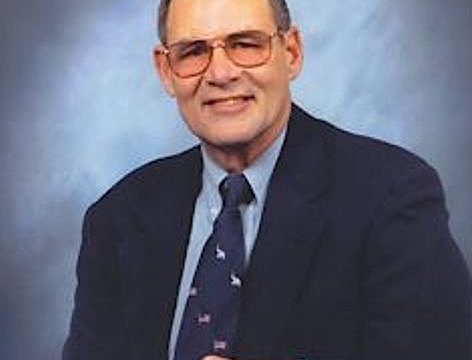 Ed Weihemayer wearing a suit and wire-rimmed glasses