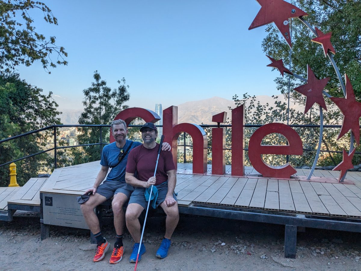 Erik and Skyler in front of the red Chile sign