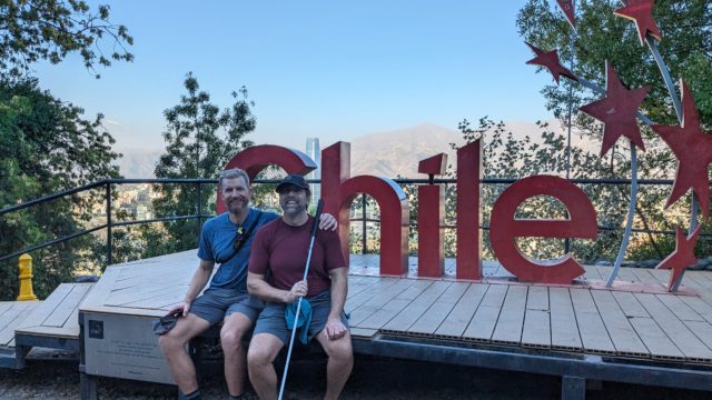 Erik and Skyler in front of the red Chile sign